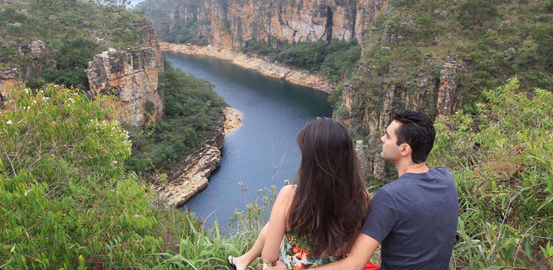 Honeymoon couple looking down upon a ravine