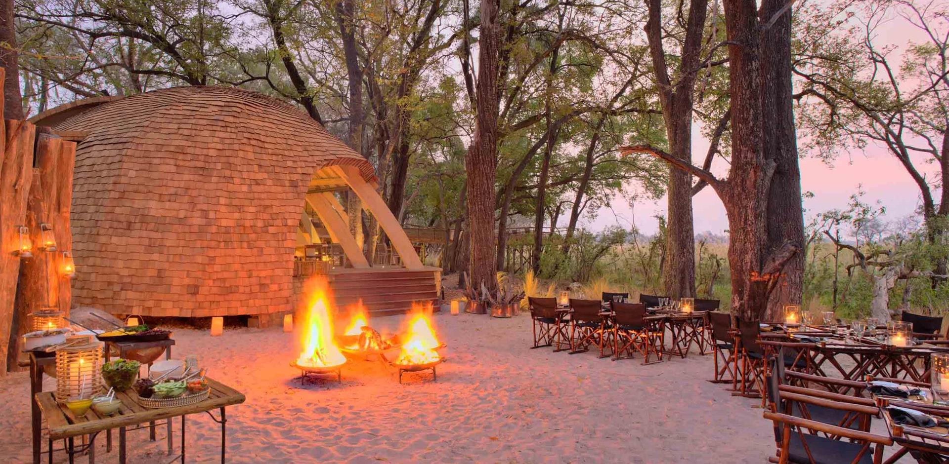 Lodge exterior and firepit, andBeyond Sandibe Okavango Safari Lodge, Okavango Delta, Botswana