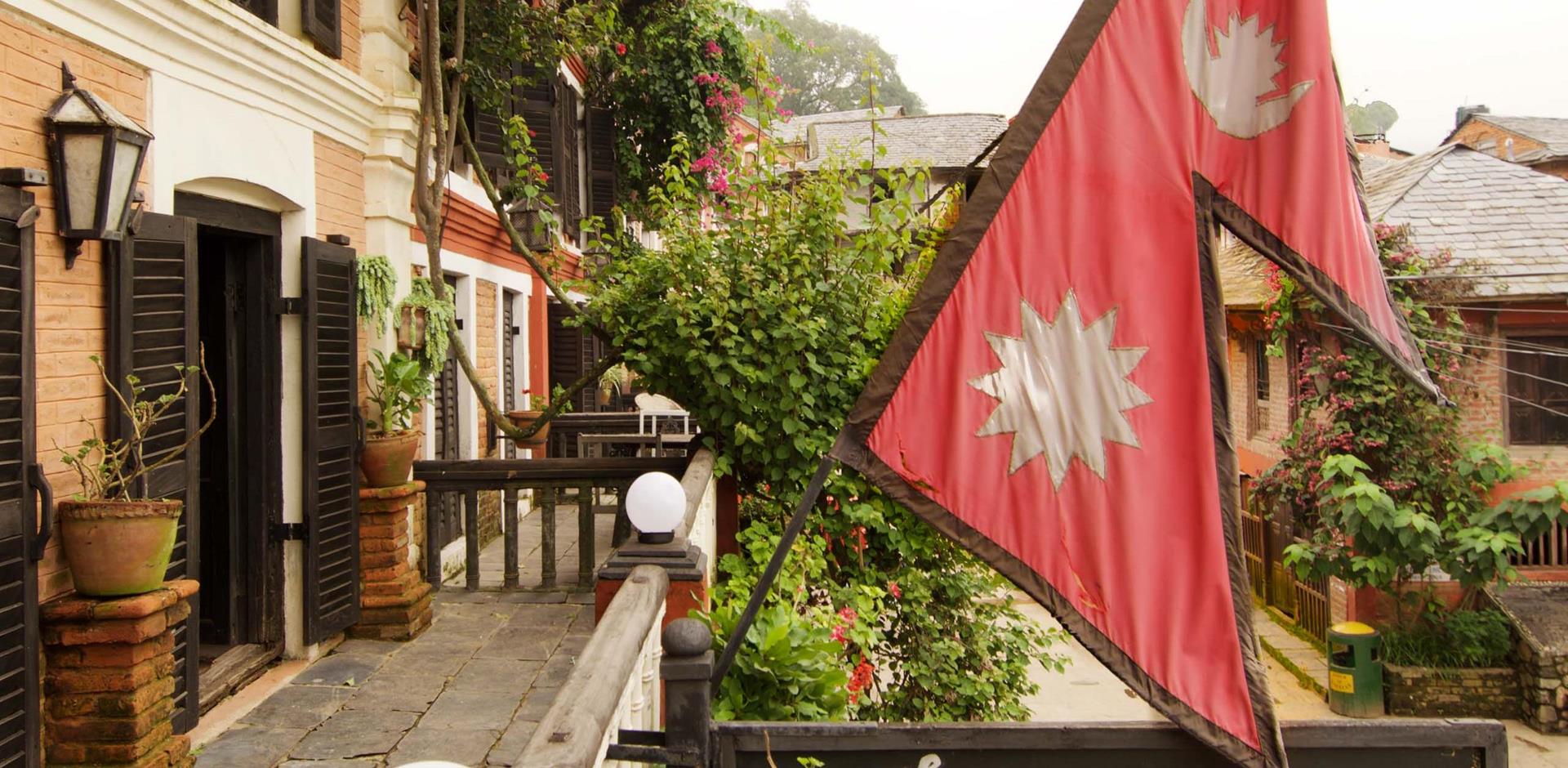 Exterior view of balcony and Nepalese national flag, Old Inn Bandipur, Nepal