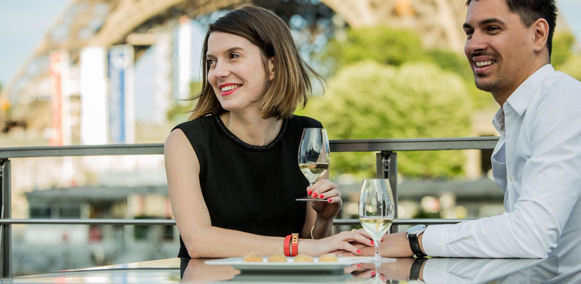 Couple enjoying a glass of wine, Ducasse sur Seine Dinner Cruise, Paris